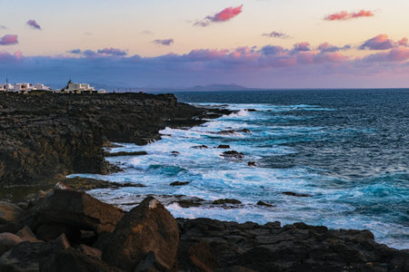 rocky coast of Playa Blanca in Lanzarote during evening lights