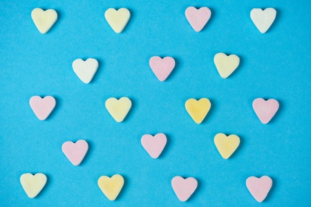 candy hearts in rows on a blue background