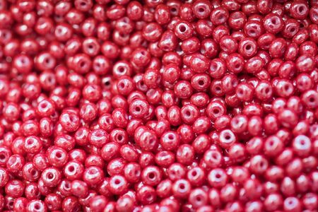 macro photo of red shiny plastic beads as backgroundの写真素材