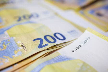 lot of blurred two hundred Euro bills filling the screen as background pictureの写真素材