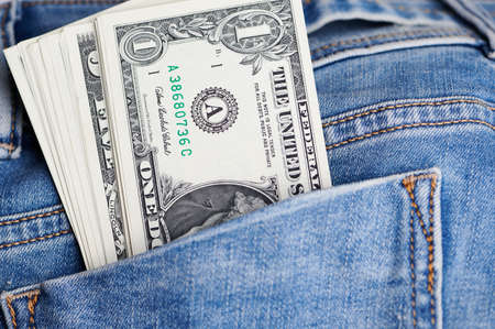 close up of dollar banknotes in a jeans pocketの写真素材