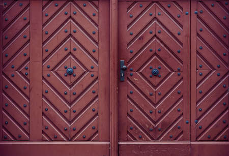 old red brown wooden front door, frame filling as background photo with copy spaceの写真素材