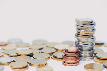 two coin towers out of Euro coins and cents against white background with copy space for any textの写真素材