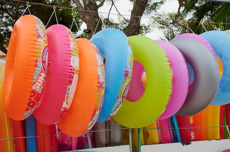 Alcudia, Mallorca - August 17, 2021: multicolored swim rings in a souvenir shopのeditorial素材