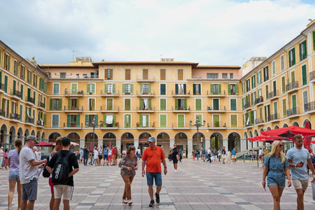 Palma de Mallorca, Spain - October 12, 2021: Tourists on the famous square Placa Mayor in Palma de...