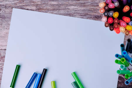white paper with copy space for any text, beside a lot of colored brush pensの写真素材