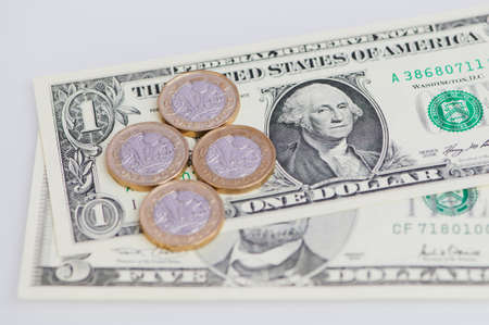 British Pound coins and US Dollar banknotes in a horizontal color macro pictureの写真素材