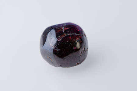 Garnet gemstone close up on white backgroundの写真素材
