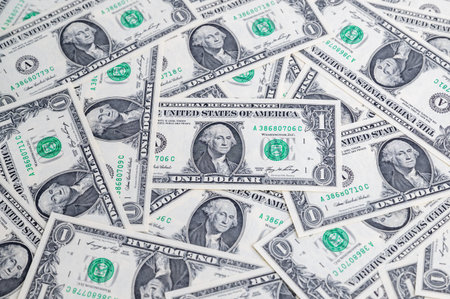 One dollar bills are spread out on a table or surface.の写真素材