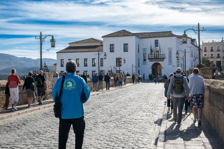 Ronda, Spain - Nov 10, 2025: People walk on the cobblestone street in Ronda village during the day.のeditorial素材