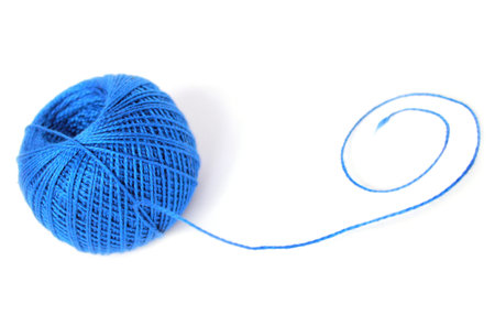 a ball of blue thread with a curl of