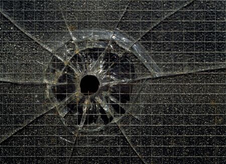 A bullet hole in industrial security glass.の写真素材