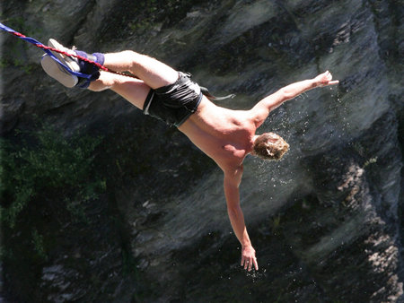 A man rebounds back after being dunked in the river during his bungee jump.