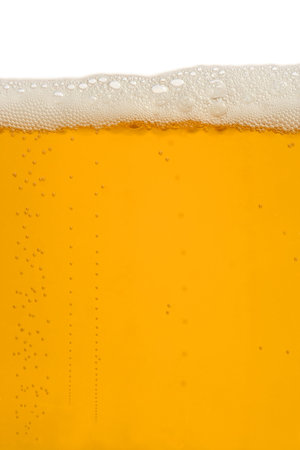 A macro image of a frothy glass of beer.