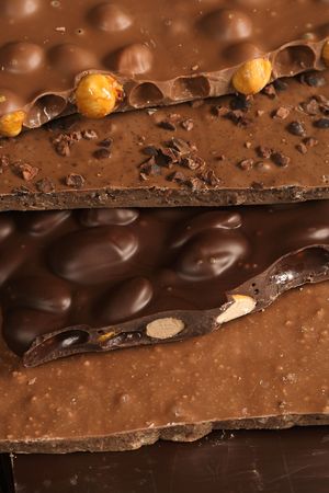 Slabs of assorted delightful chocolate goodness stacked on top of each other. Sweet!の写真素材