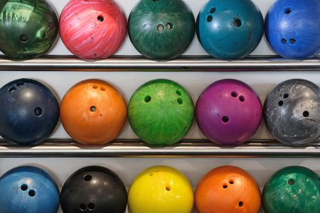 A rack of old worn bowling ballsの写真素材