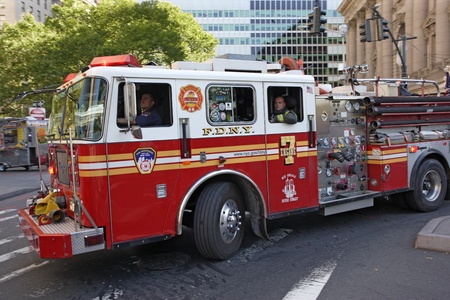 New York City, New York, USA - October 9, 2010: New York City Firefighters in a fire engine rushing to an emergency.のeditorial素材