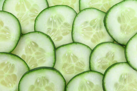 Photo of cucumber slices as a background.の写真素材
