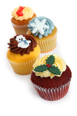Photo of four cupcakes decorated for Christmas. Focus on first cupcake.の写真素材