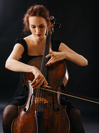 Photo of a beautiful female musician playing a celloの素材