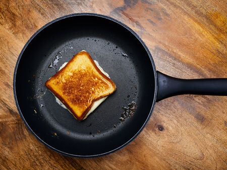 grilled cheese sandwich cooking in a large frying pan.の写真素材