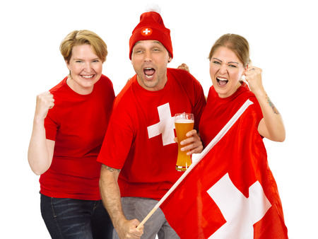 Photo of three Swiss sports fans cheering for their team.の写真素材