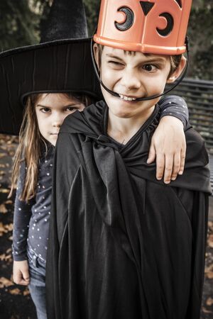Brother and sister being silly and getting ready to go out for Halloween.の写真素材