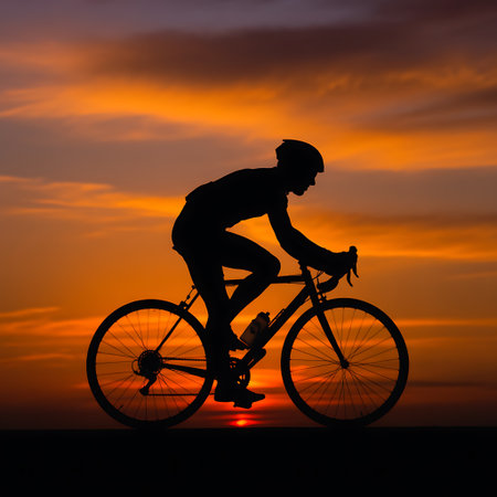 Silhouette of a cyclist against the background of the setting sunの素材