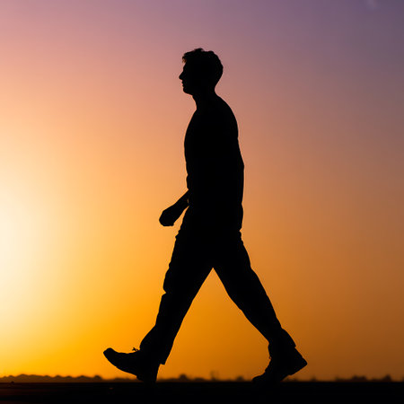 Silhouette of a man walking in the sunset. The concept of active lifestyle.の素材