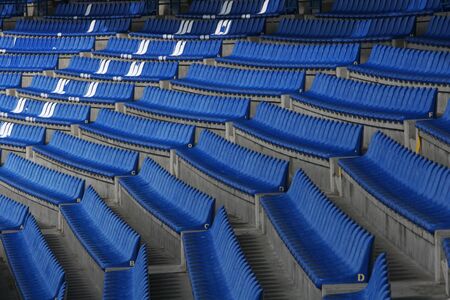 Blue audience seats at a football stadiumの写真素材