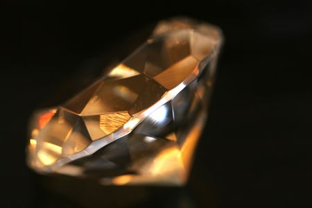 A clear diamond isolated on blackの写真素材