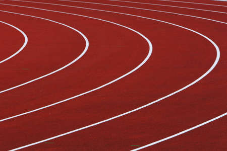 red running tracks with white dividing lines with a left hand turnの写真素材