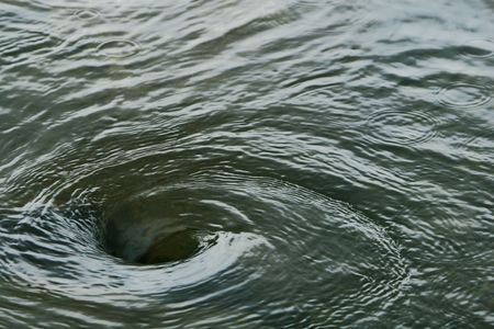 A swirling vortex in waterの写真素材