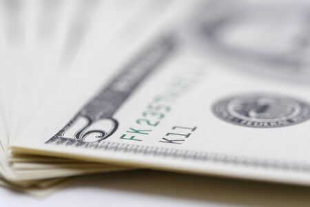 A close up of a bunch of 5 dollar bills, very shallow focusの写真素材