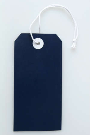 a blank dark blue label tag with string attachedの写真素材