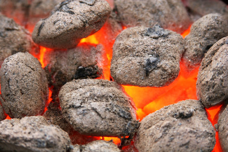 charcoal brickets burning down, close up shot