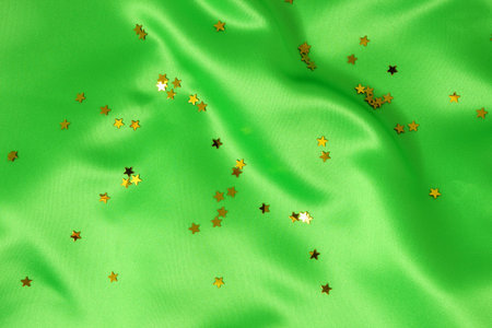 green satin with golden stars, great celebration background