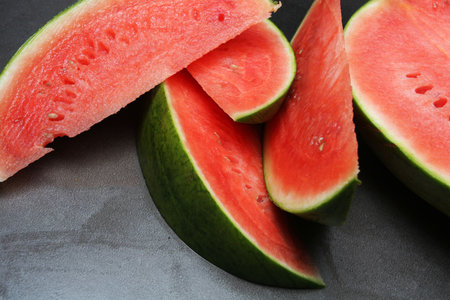 cut watermelon on a dark grey background