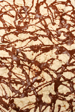 a cropped shot of the top of a big cake decorated with molten chocolateの写真素材