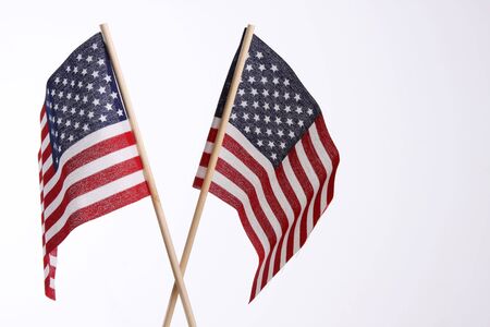 two small us flags meant for use in national holidays and celebrationsの写真素材