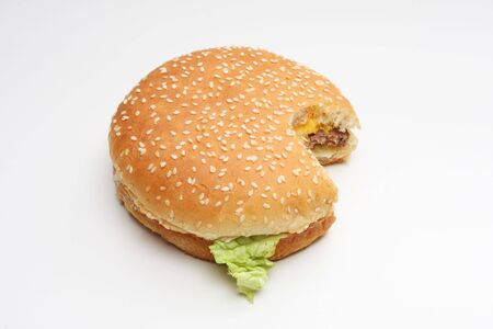 Hamburger isolated on white, one bite taken out of itの写真素材