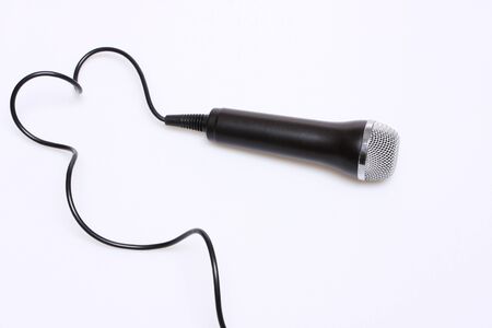 A simple microphone isolated on white with black cordの写真素材