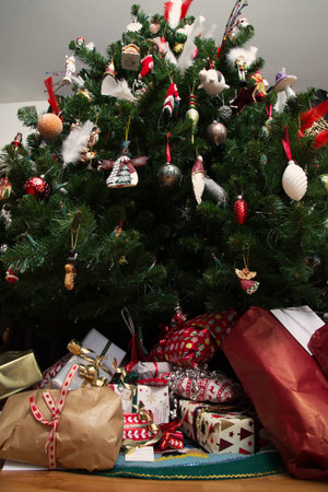 Christmas presents under a christmas tree, shot from below with a wide angle lensの写真素材
