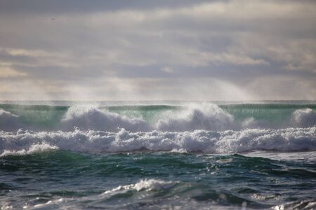 waves of the north atlantic ocean crashing on an icelandic beach after a stormの写真素材