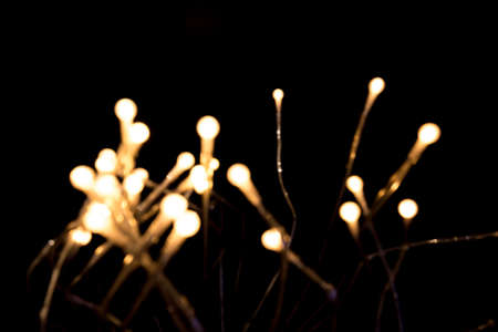 Blurry christmas lights set against blackの写真素材