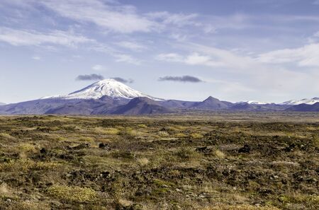 The volcano Hekla in Iceland shot in autumn, old overrgrown lavafield in the foregroundの写真素材