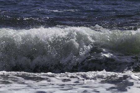 Big wave on the north atlantic ocean crashing onto the black beach in icelandの写真素材