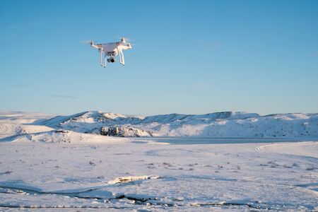 Quadcopter flying over winter landscape in Iceland, being used for aerial video og photography.の写真素材