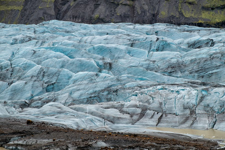 Svinefellsjokull outlet glacier in Iceland, shot on a overcast day in summer. Textured ice and blue color castの写真素材