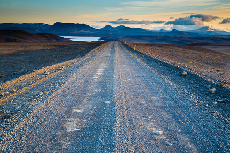 Road leading into the distance under a dramatic skyの写真素材